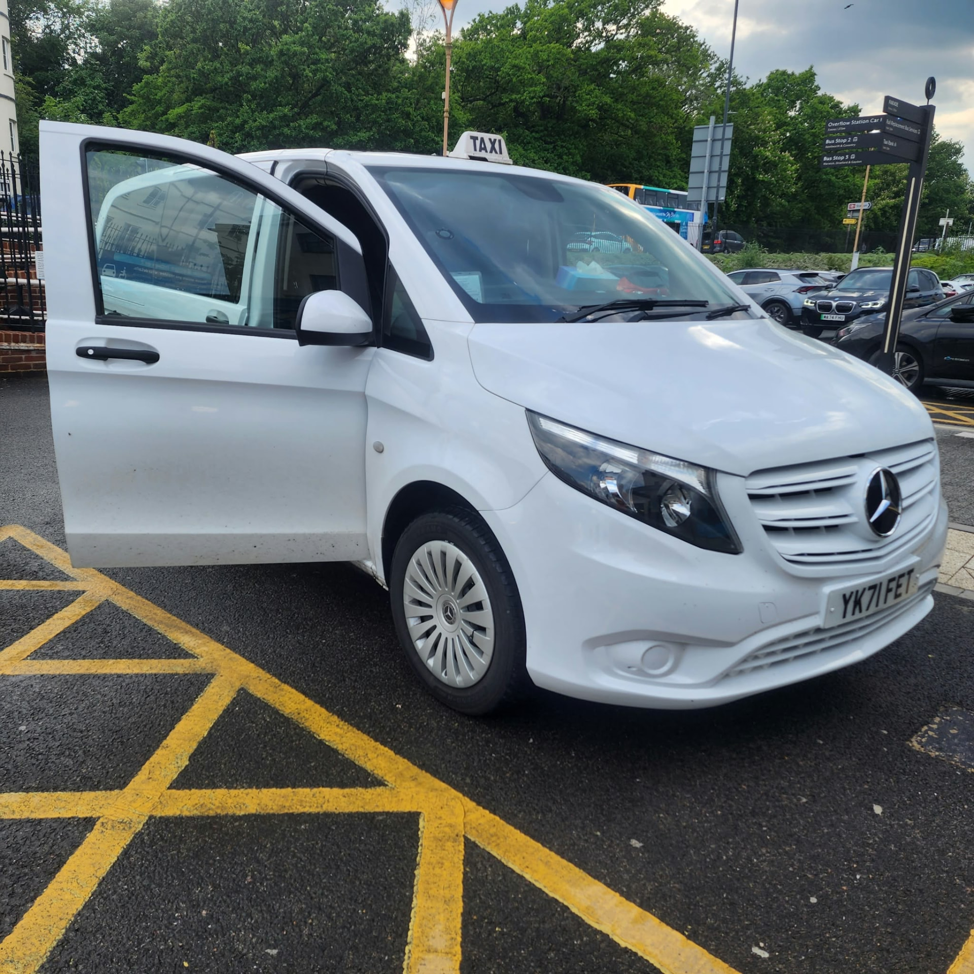 Local Taxi 8 seater white Mercedes Vito with a taxi roof sign
