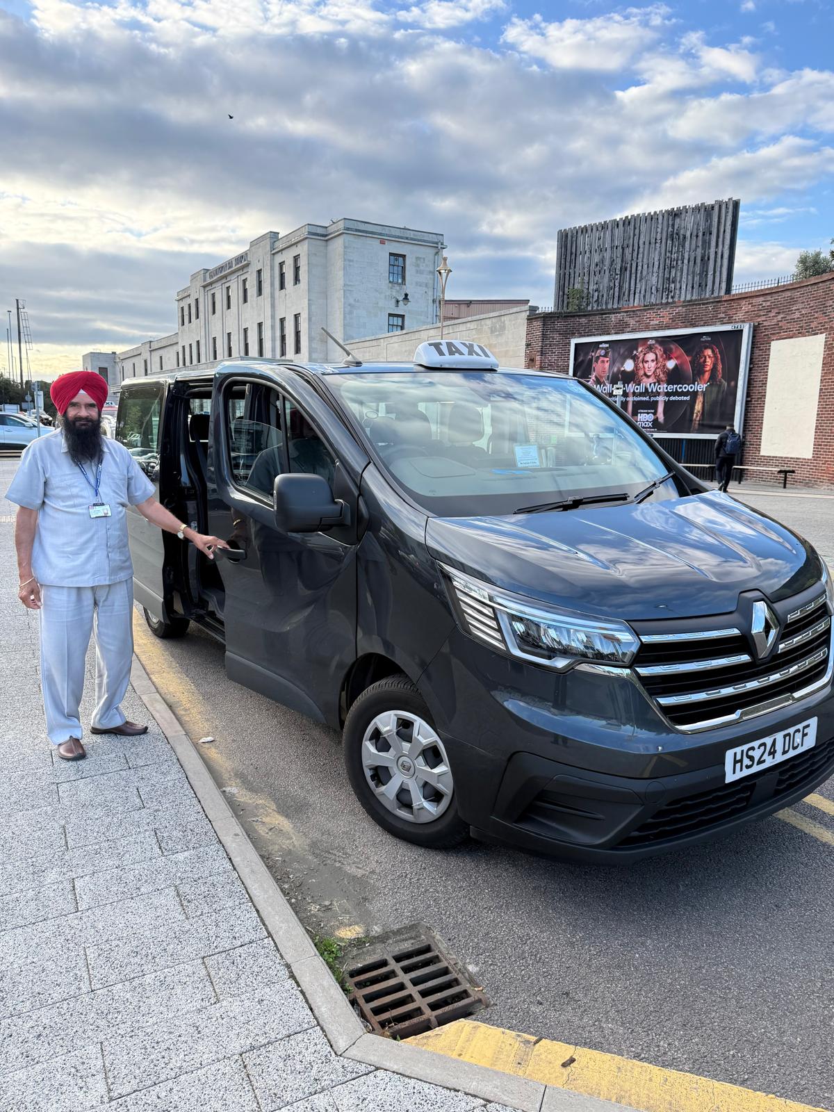 Local Taxi driver beside a dark people carrier used for Bishop's Tachbrook journeys