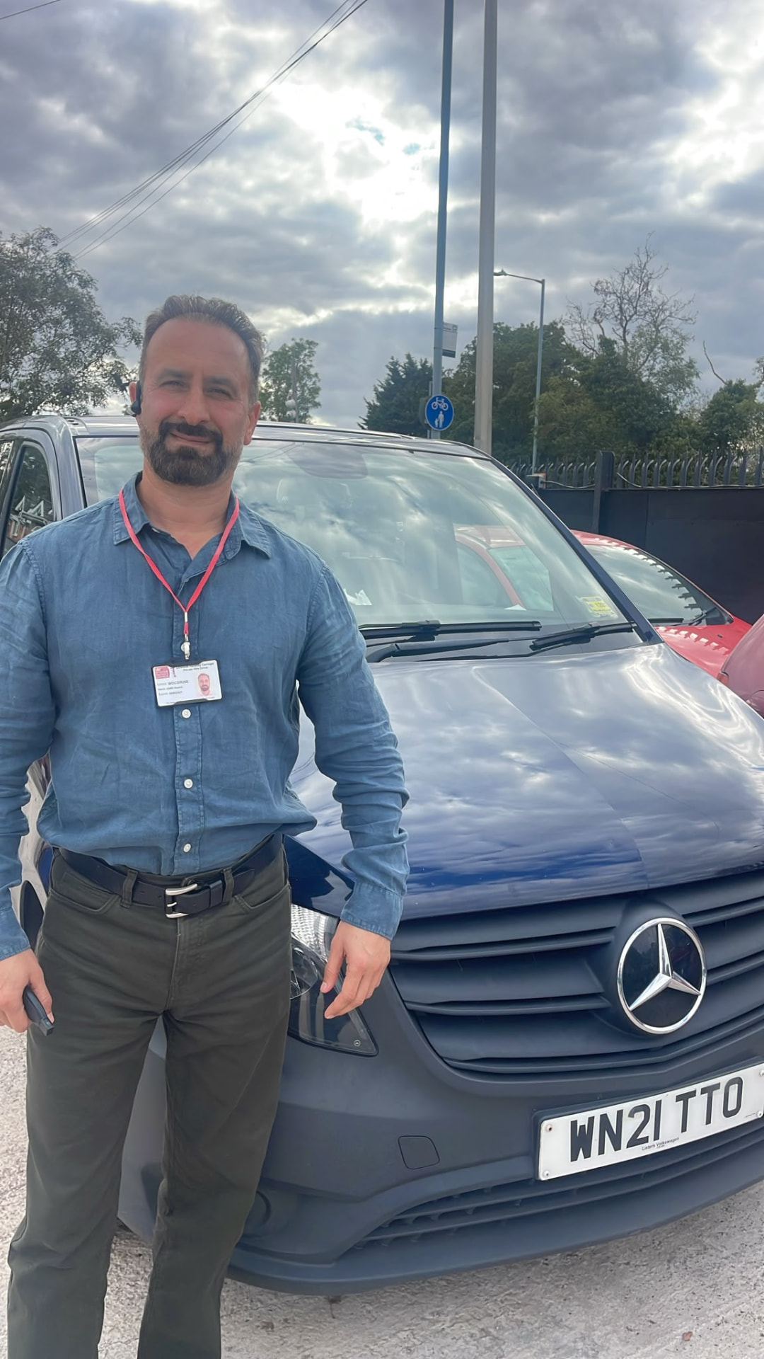 Local Taxi driver standing beside an 8 seater Mercedes Vito